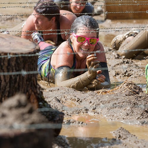 competitor crawling through mud
